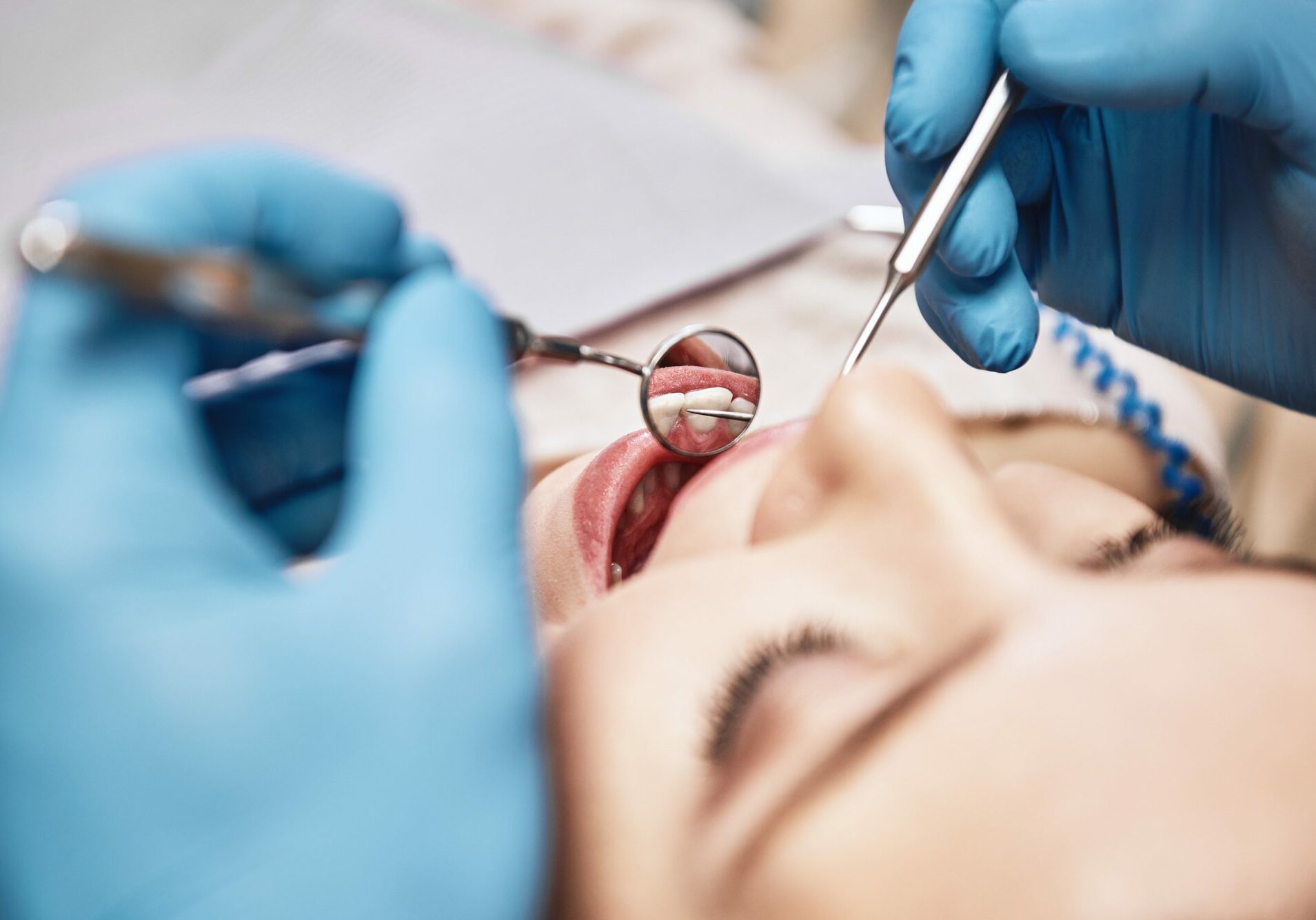 A female patient has an oral cancer screening as part of her 6-month dental visit at West Richland Family Dental